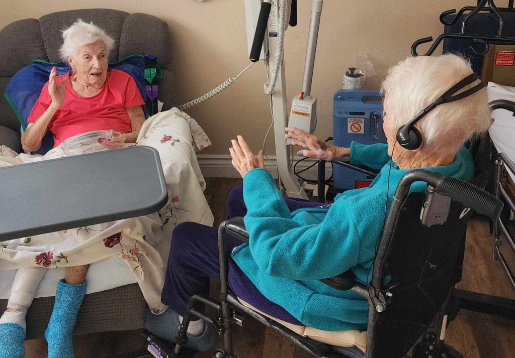 talking two women in a residents room talking