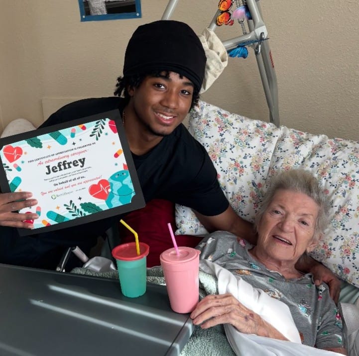 certificate a caregiver holding a certificate and a woman lying in a bed