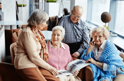 Gather a group of older people sitting on a couch